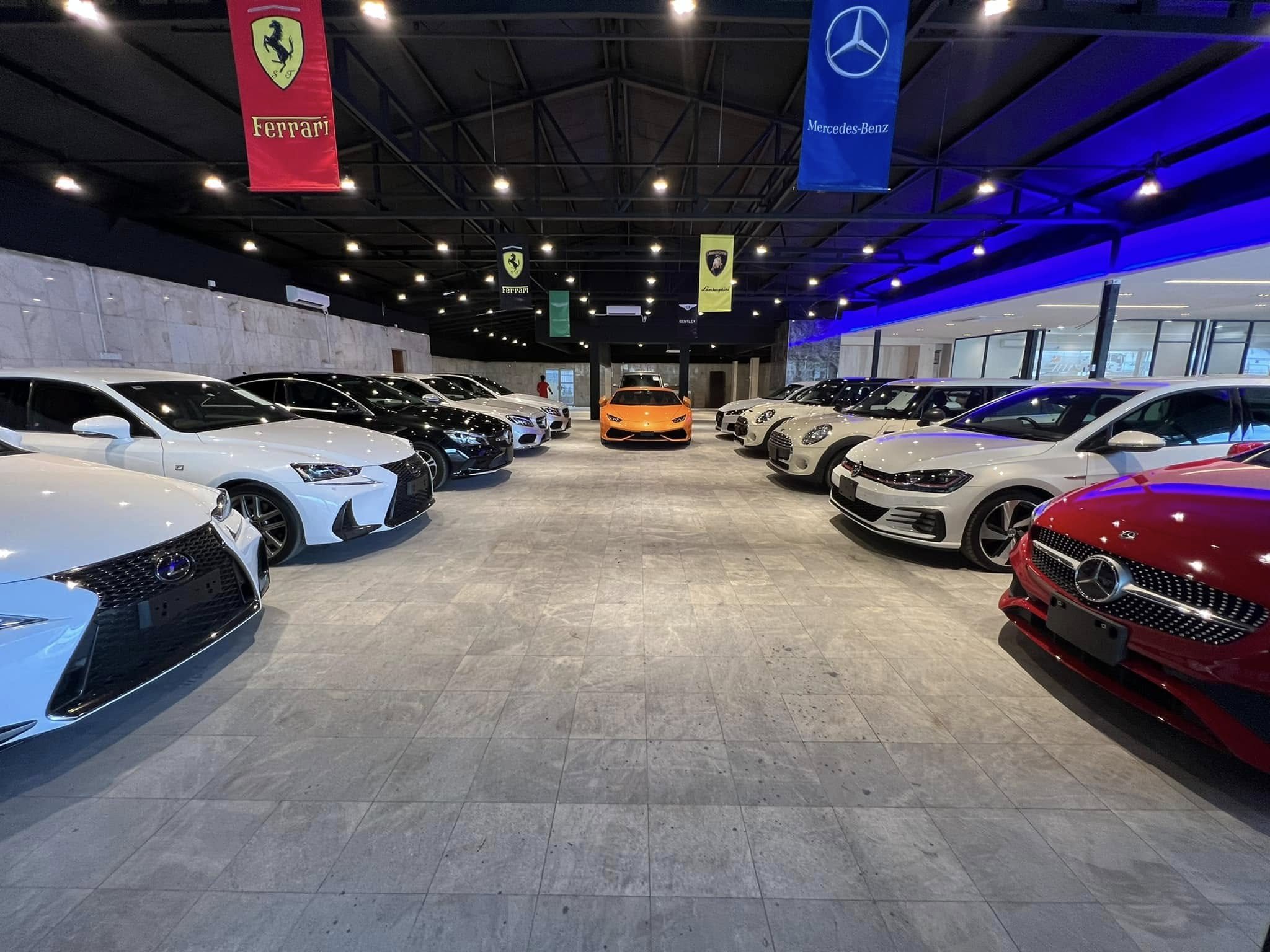 Inside the ISMO Automobiles showroom in Ipoh, with rows of recond cars and an orange Lamborghini at the far end